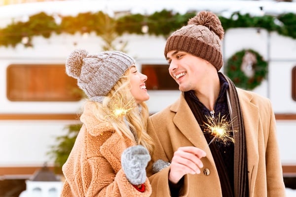 a man and woman are holding sparklers and smiling at each other