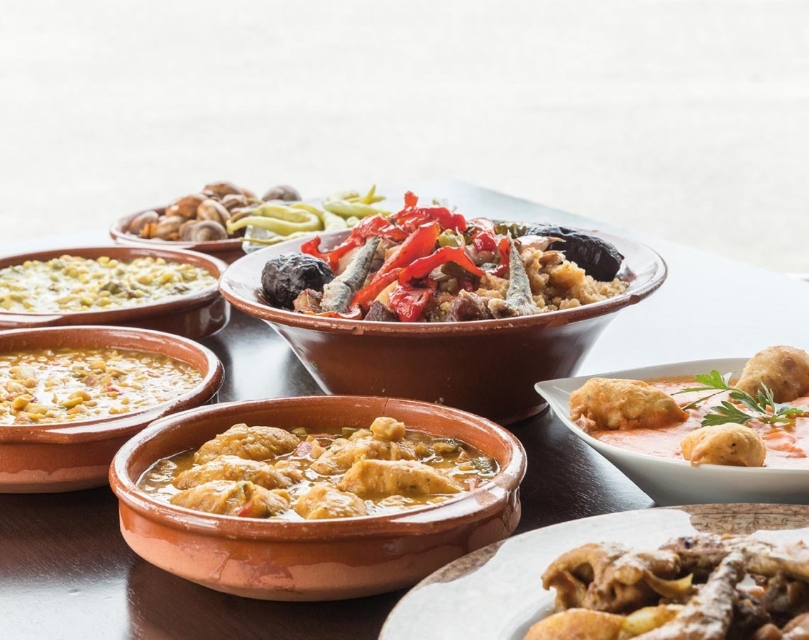 a table topped with bowls and plates of food