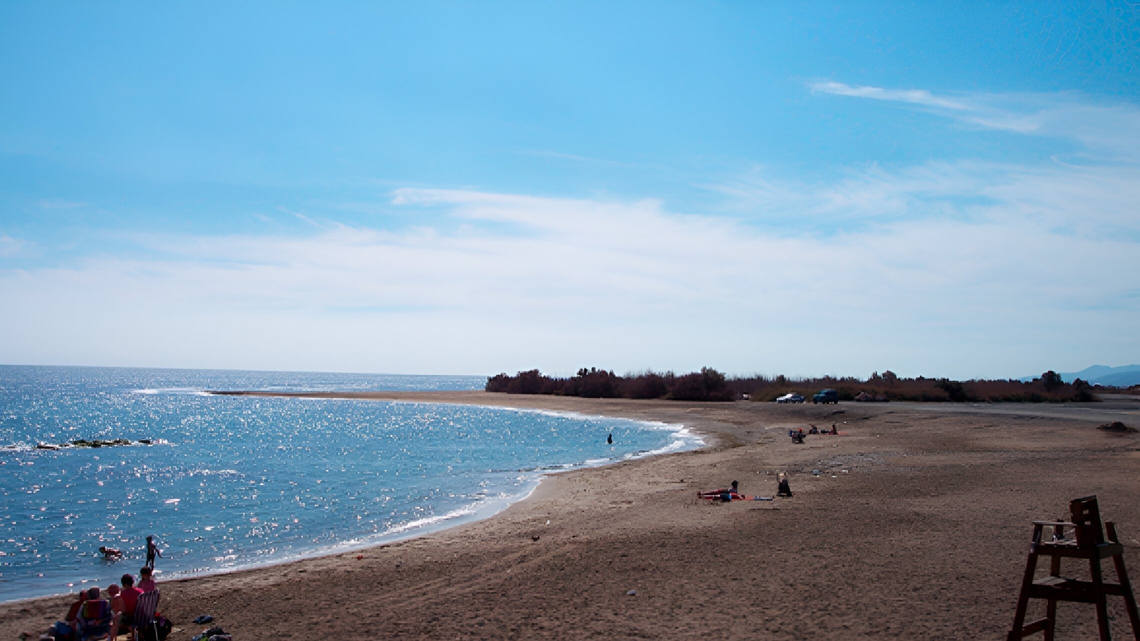a beach with a lifeguard chair in the foreground