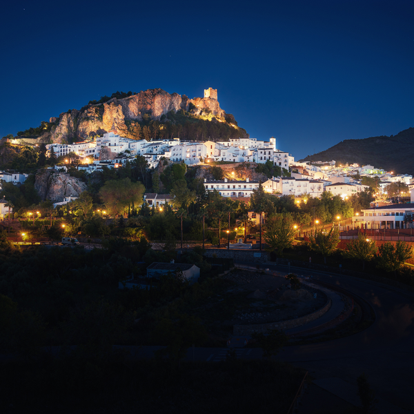 a small town sits on top of a hill at night
