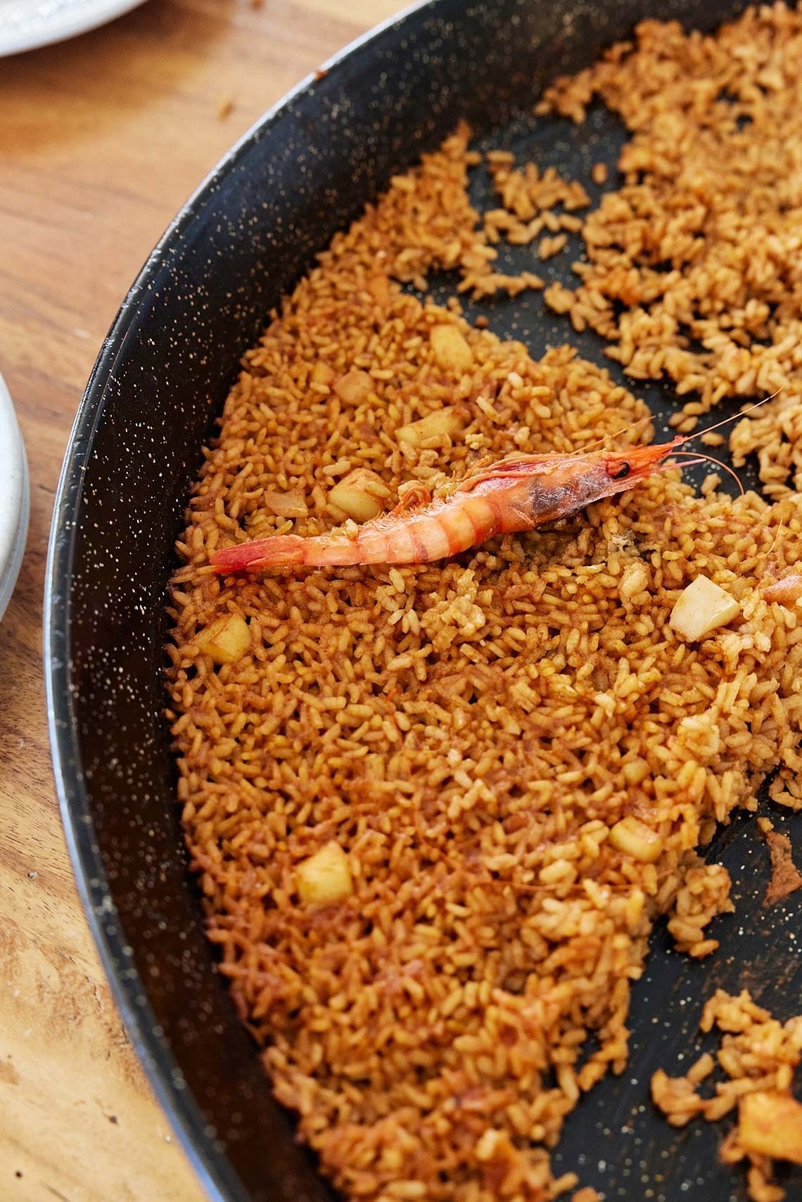 a pan of rice with a shrimp in it