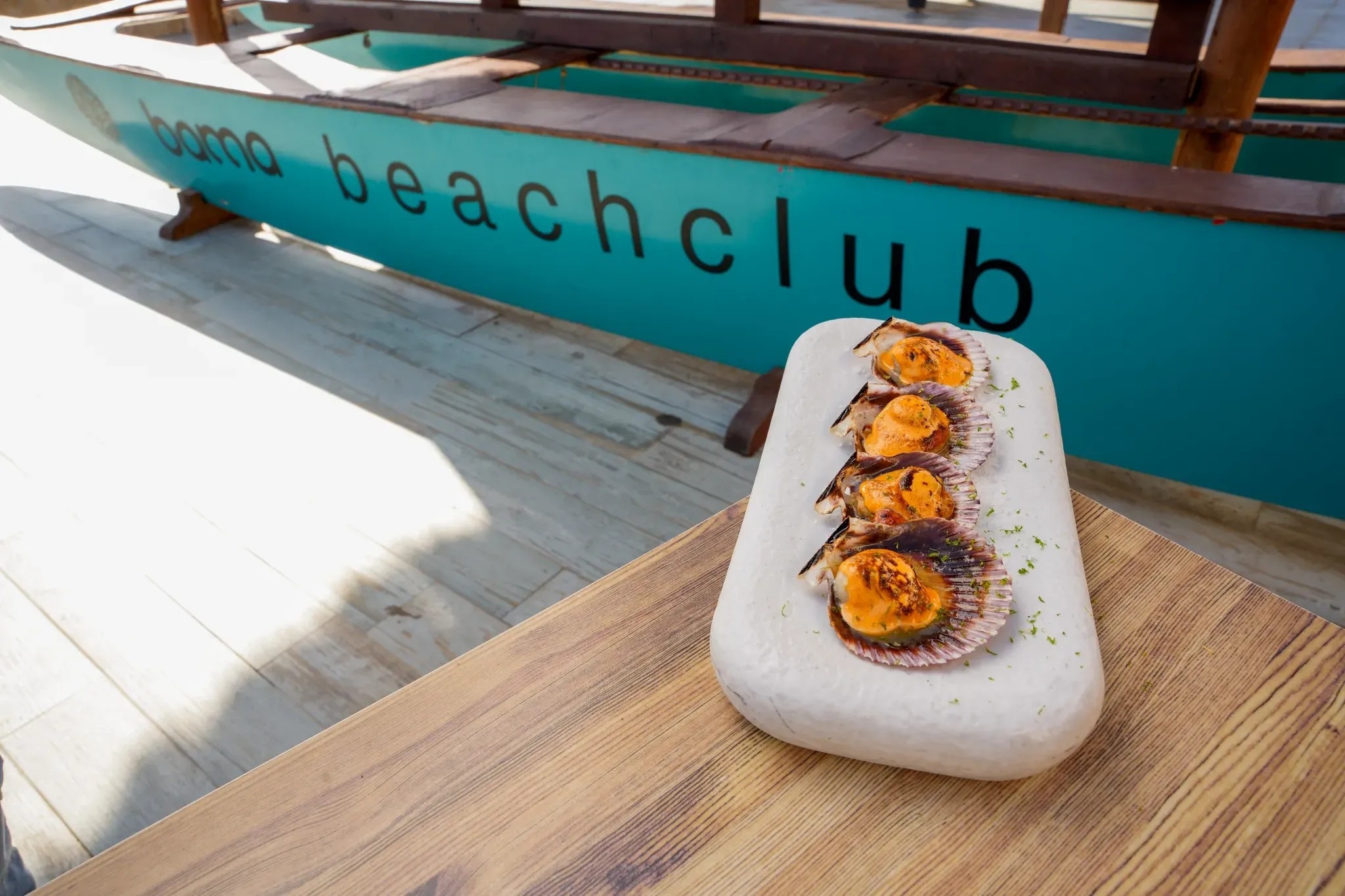 a blue boat with the word beach club on it