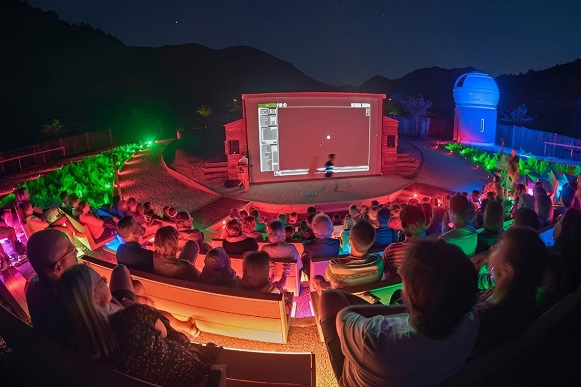 two little girls are running in the grass holding hands