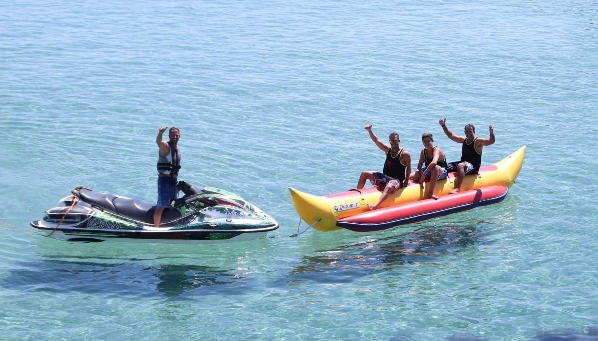 a sandy beach with waves crashing on the shore