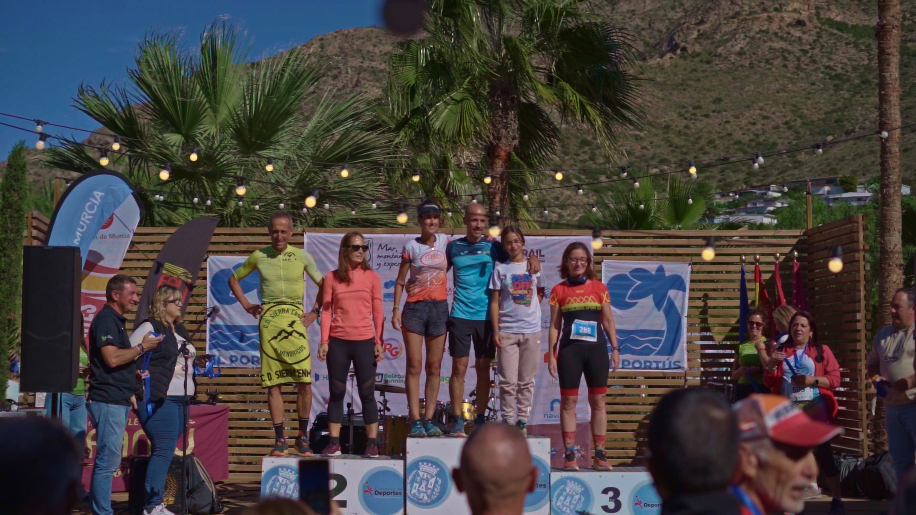 Podium finishers at the Murcia Taiga: Corporativa race, celebrating their achievements with medals and awards.