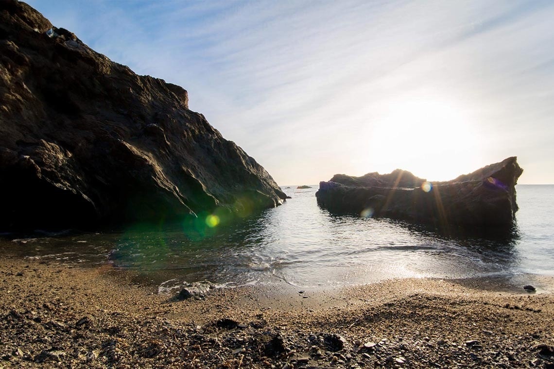 the sun shines brightly over a body of water