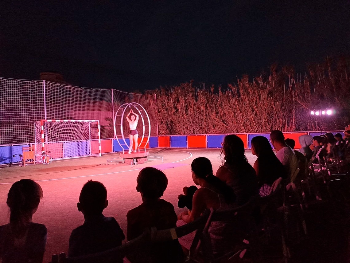 a group of people watching a performance with a sign that says ' a ' on it
