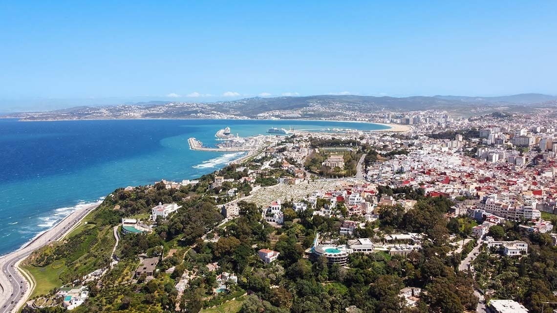 an aerial view of a city near the ocean