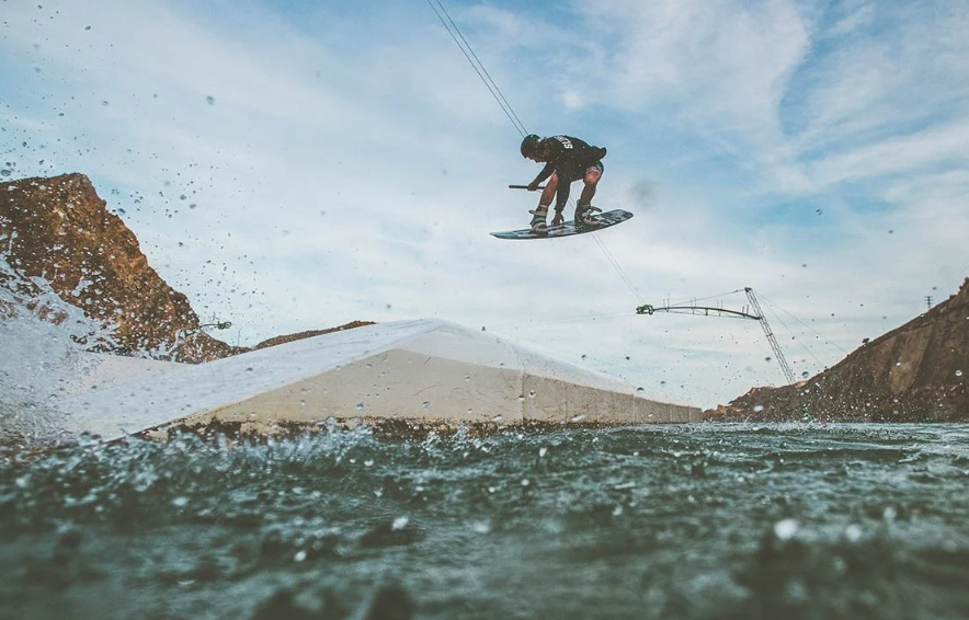 a person is riding a board in the air and they are wearing a shirt that says ' a ' on it