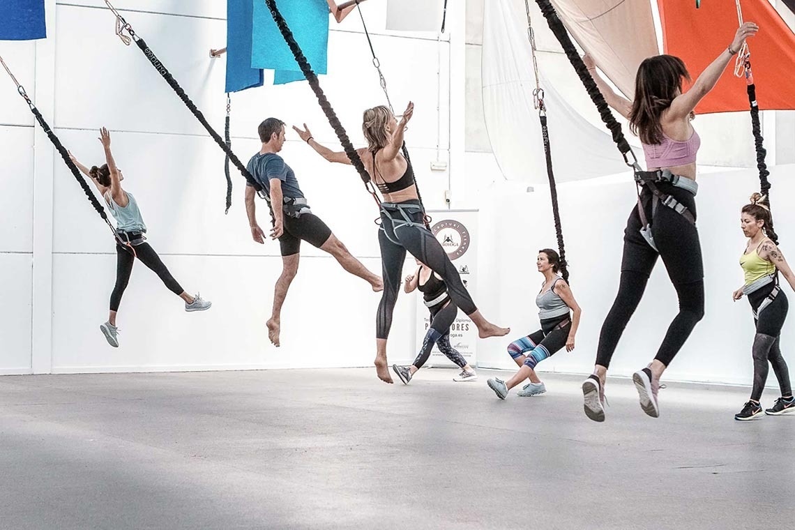 a group of people are jumping in the air in front of an adidas sign