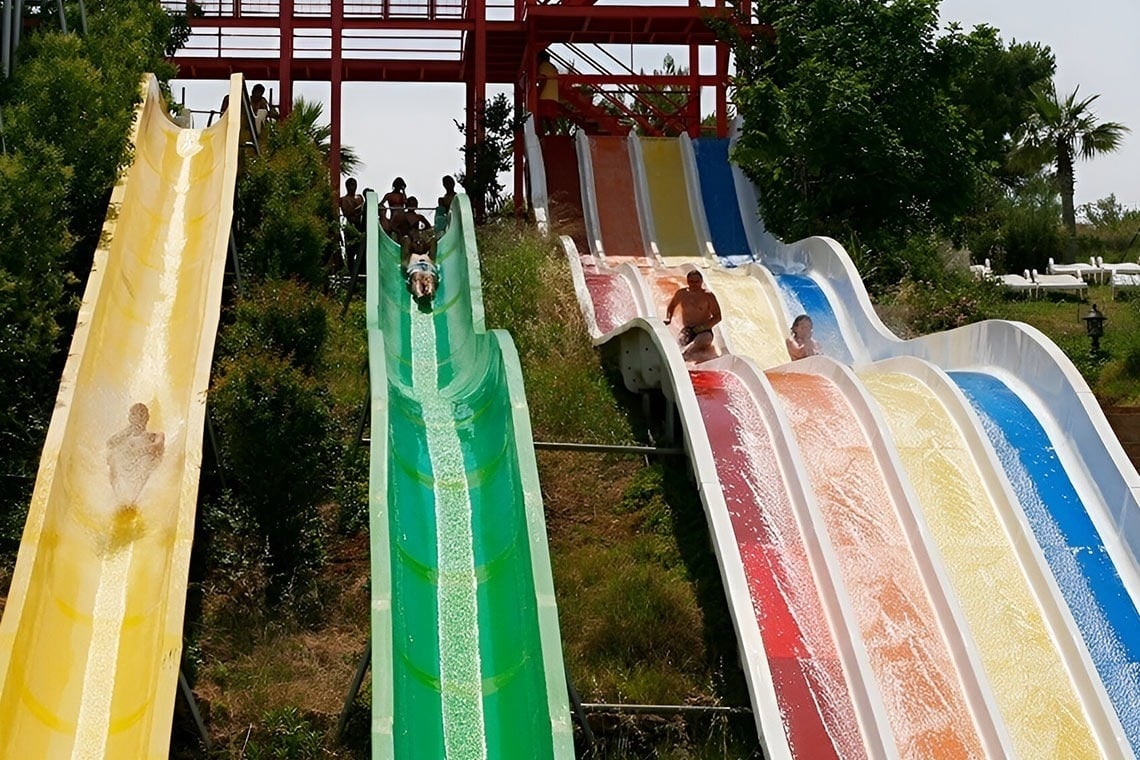 a man and a woman are riding horses on the beach