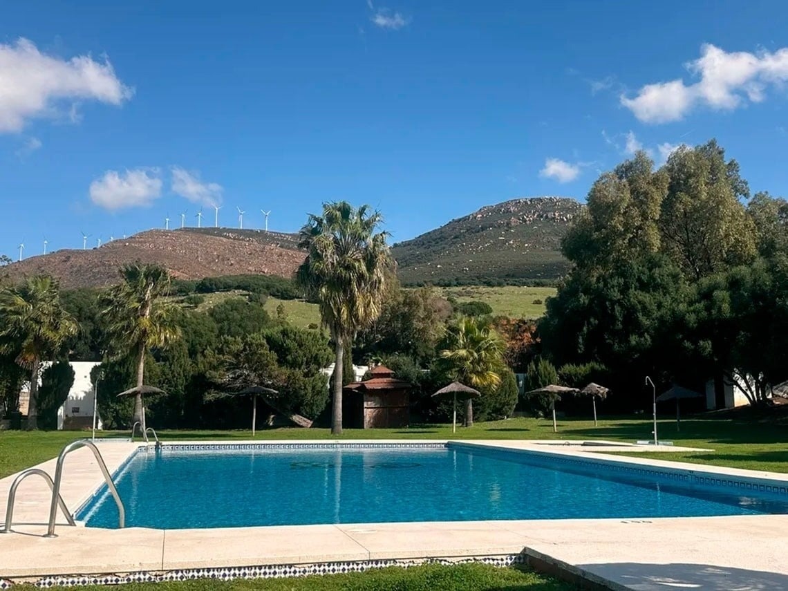 a large swimming pool with a mountain in the background