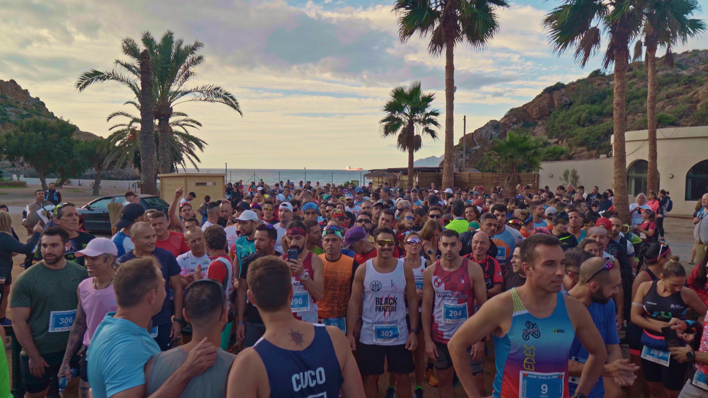Runners at start line of a trail race, palm trees, sea, and mountains Taiga: Corporativa hotel near beach.