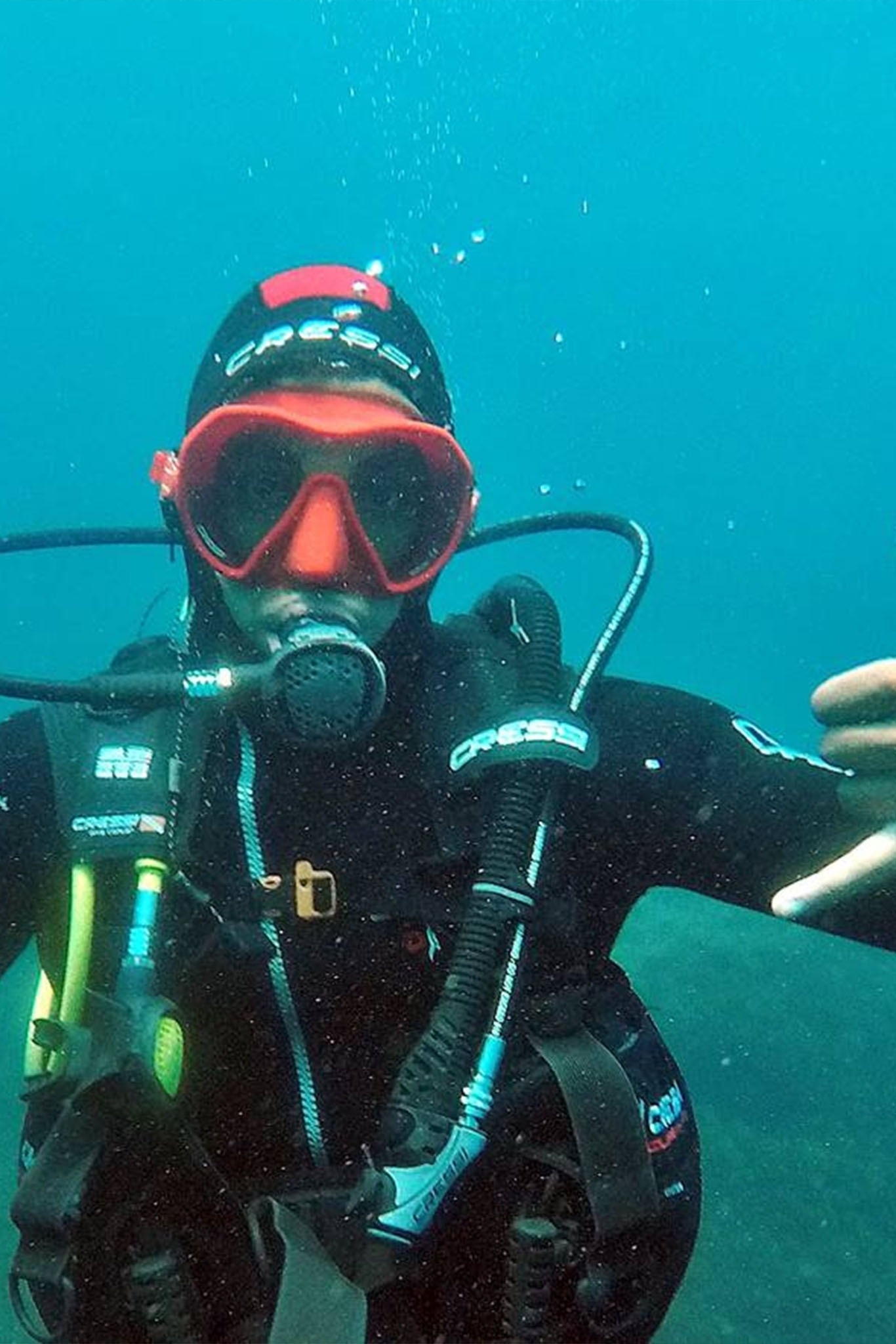 a scuba diver is wearing a black cressi wetsuit
