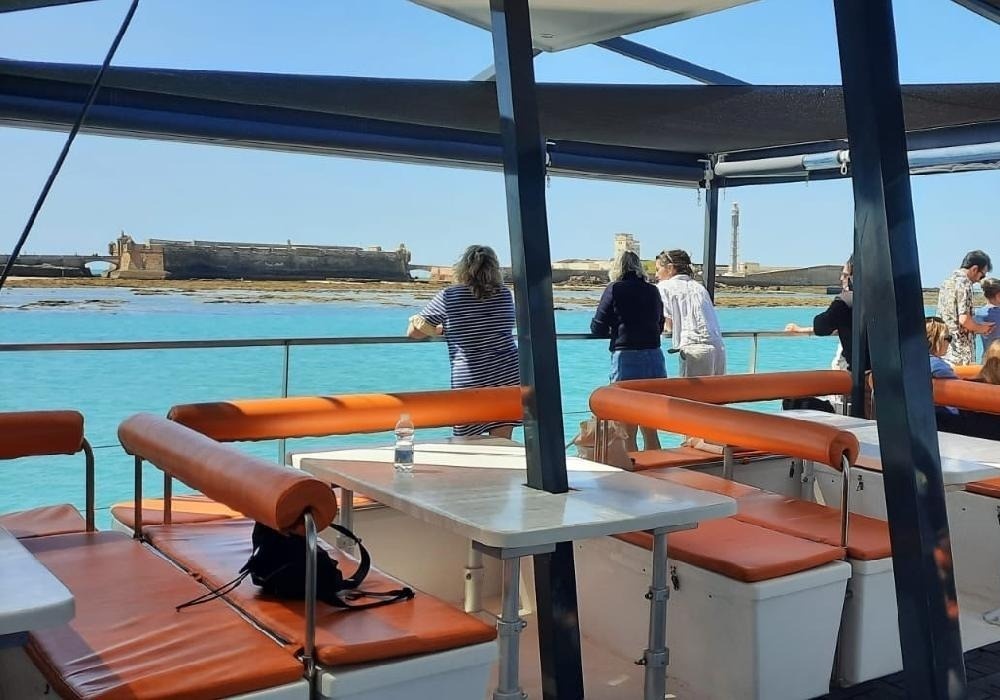 a group of people on a boat looking at the water