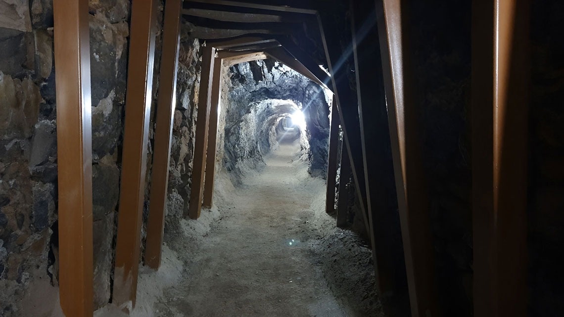 a dark tunnel with a light at the end