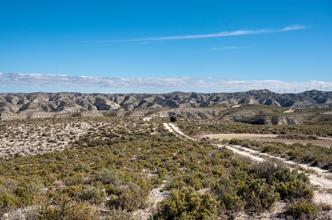 eine Landschaft mit Bergen und einem Dorf im Vordergrund .