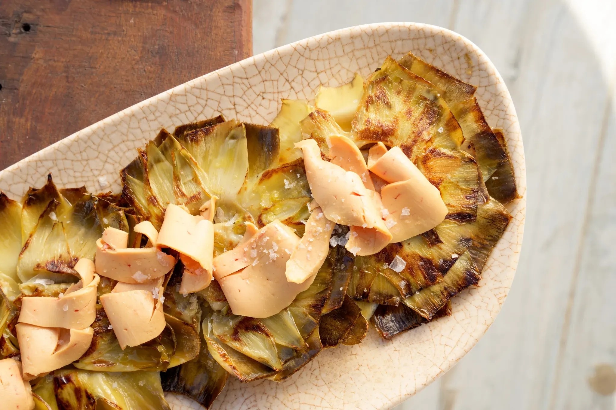 a plate of artichokes with slices of cheese on top