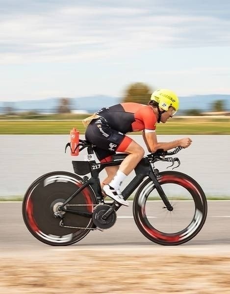 a man is riding a bike with the number 217 on the front wheel