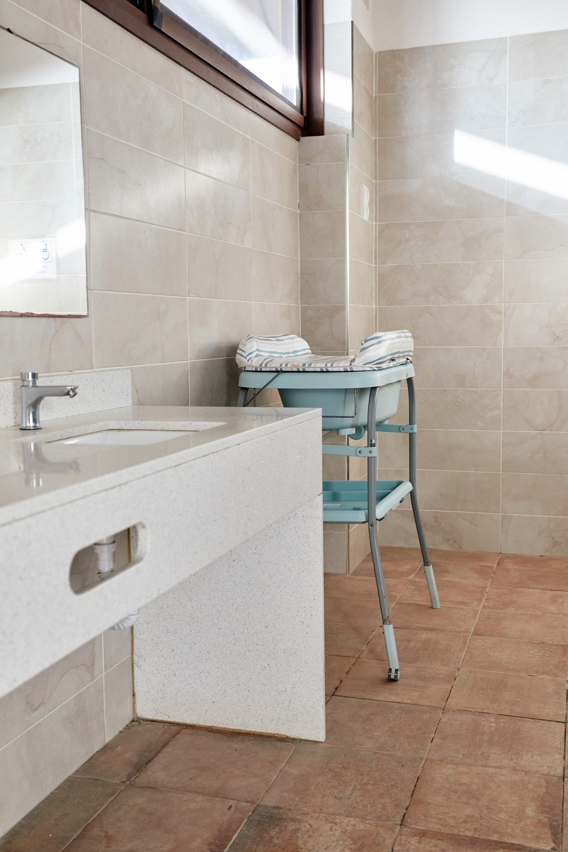 a bathroom with a sink and a changing table