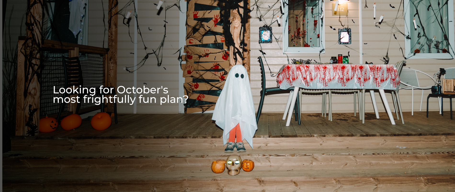 Three kids in Halloween costumes TAIGA Almería Playa | TAIGA | Campsites & Resorts in Spain stand on a porch decorated for Halloween.