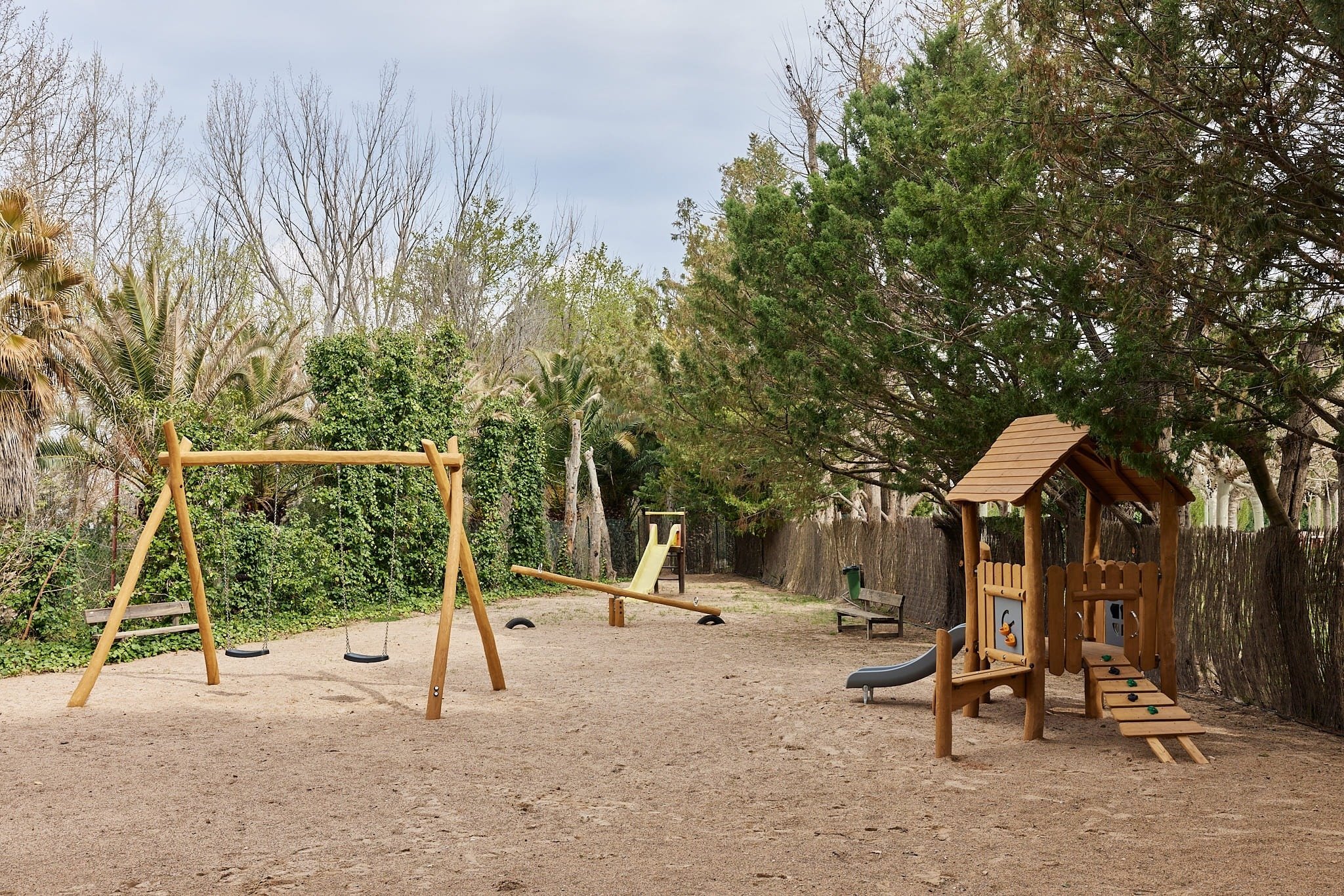 un parque infantil con columpios y un tobogán