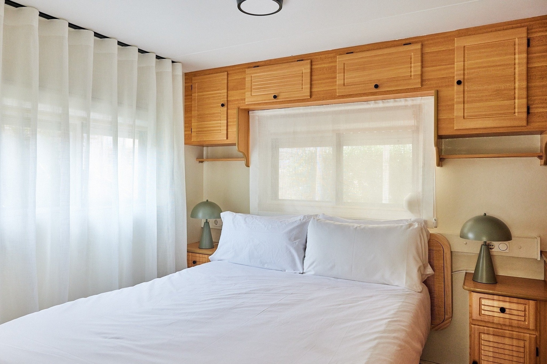 a bedroom with a bed and two lamps