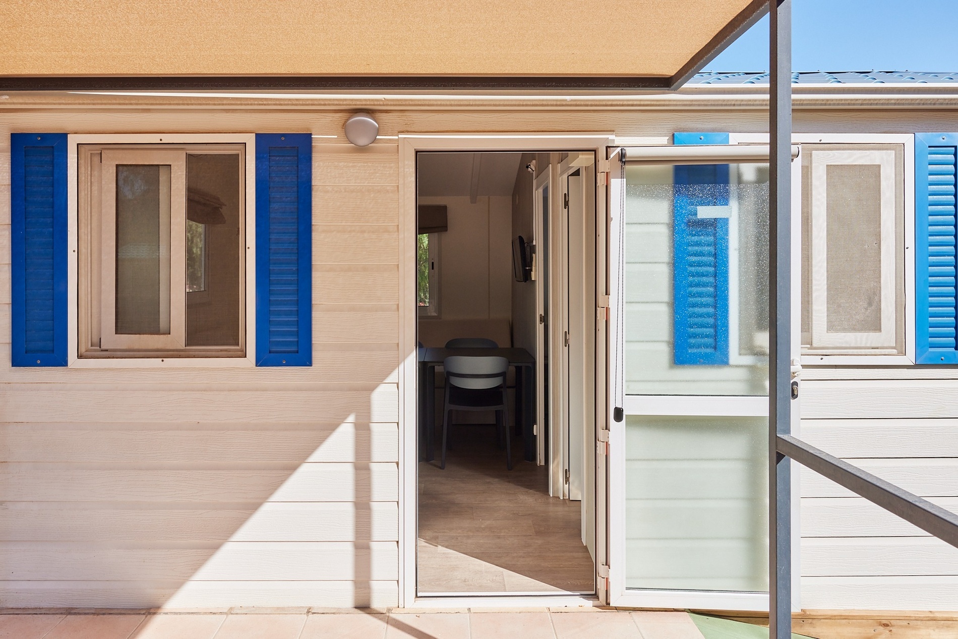 a white house with blue shutters on the windows