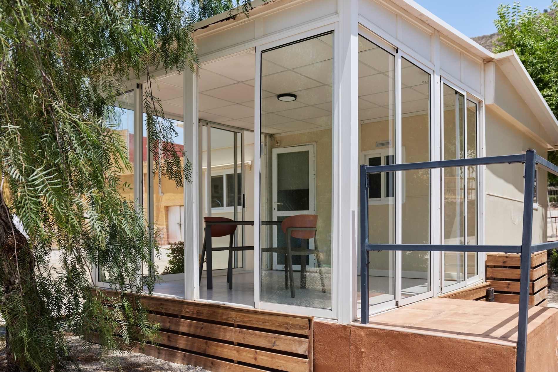 a white house with a lot of glass doors