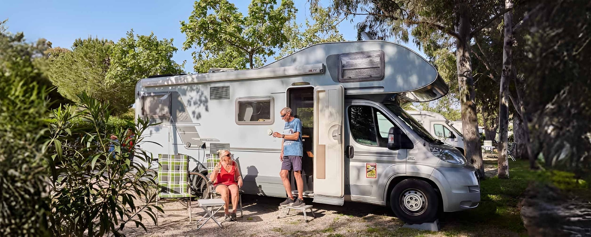 a man standing outside of a camper with a sticker on it that says ' camper '