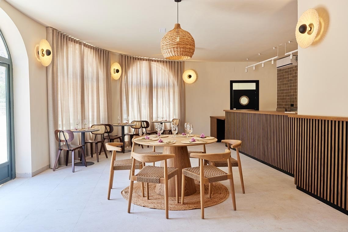 a dining room with a round table and chairs