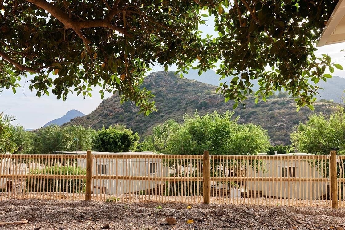a wooden fence with a mountain in the background