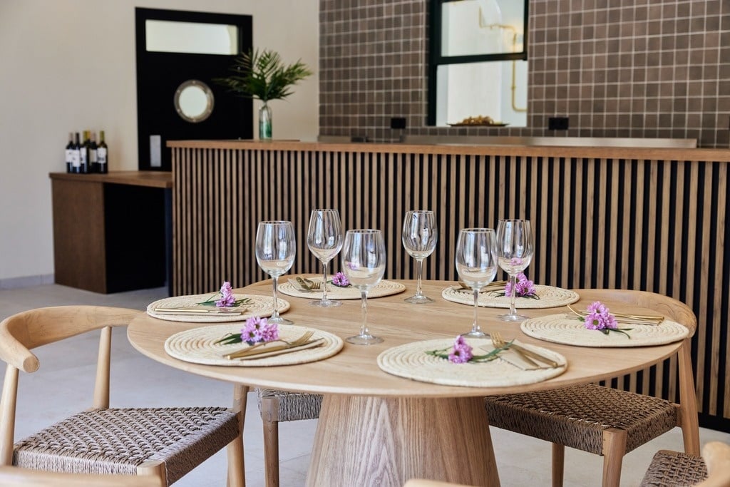a group of people sit at tables outside a building with a sign that says bar