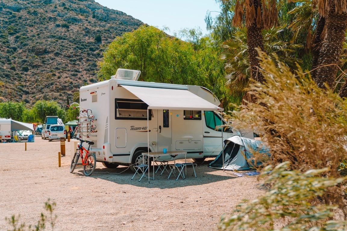 una furgoneta camper está estacionada en un camping