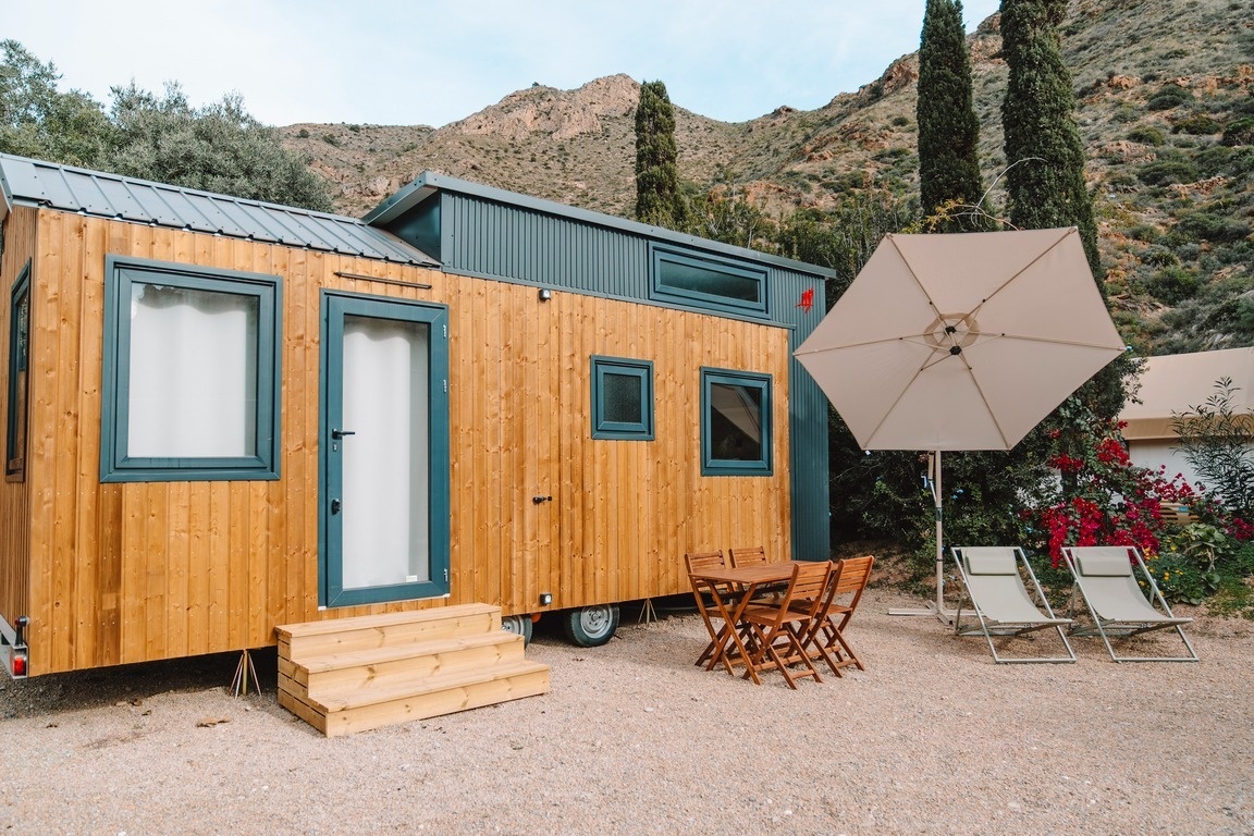 a room with a bunk bed and a table with plates and glasses on it .