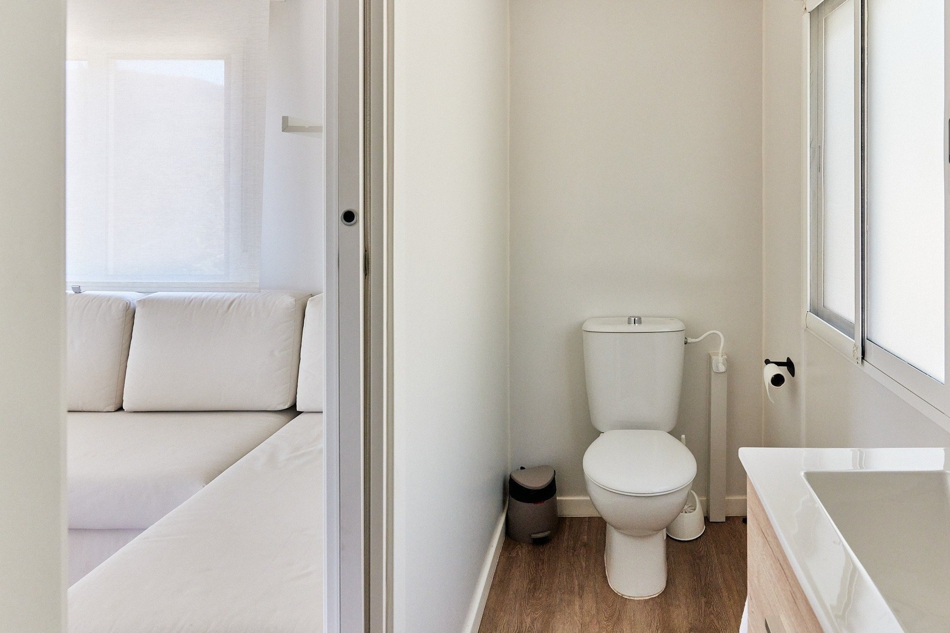 a toilet sits in a bathroom next to a sink