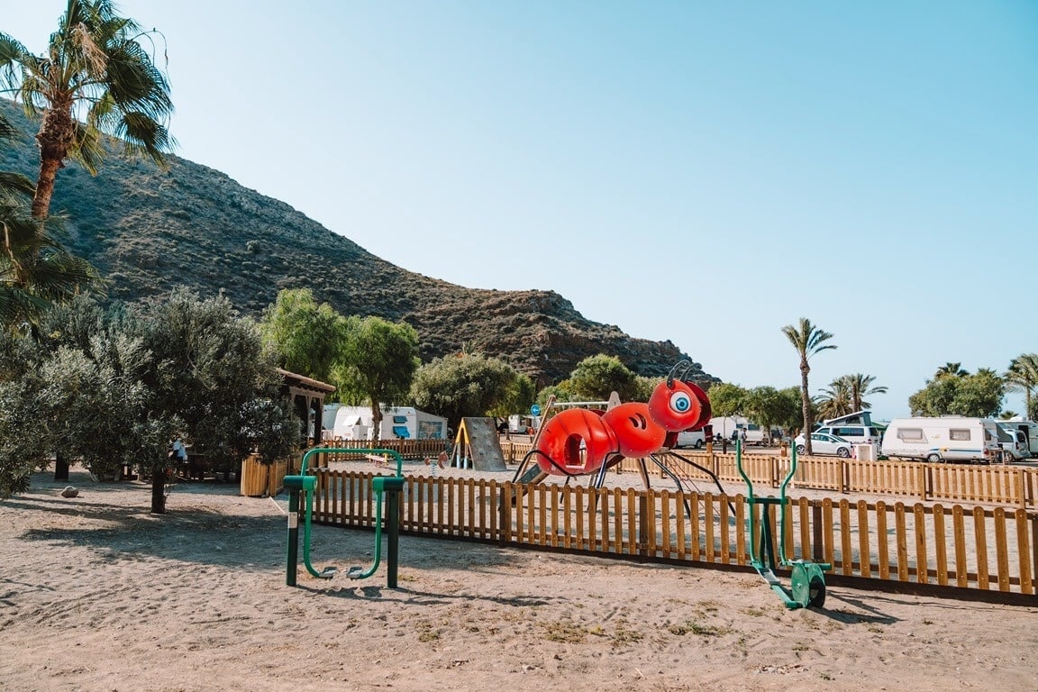 eine Frau hält einen blauen Wäschekorb voller Wäsche