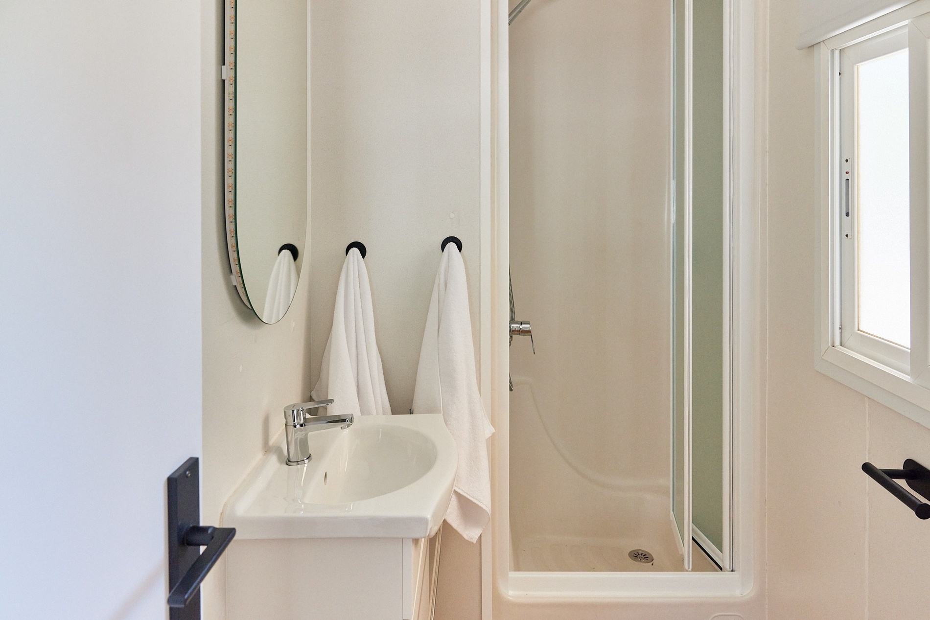 a bathroom with a sink a mirror and a shower