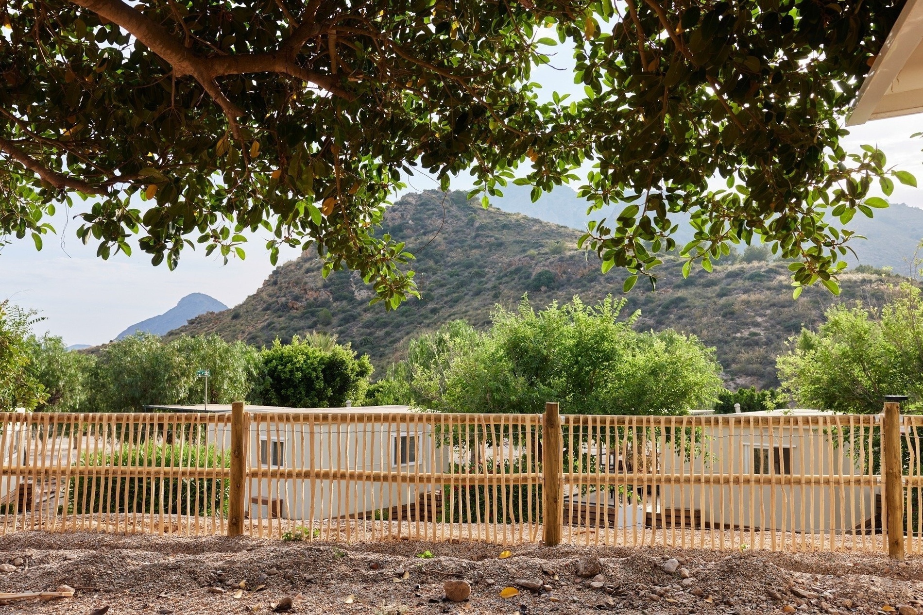a wooden fence with a mountain in the background
