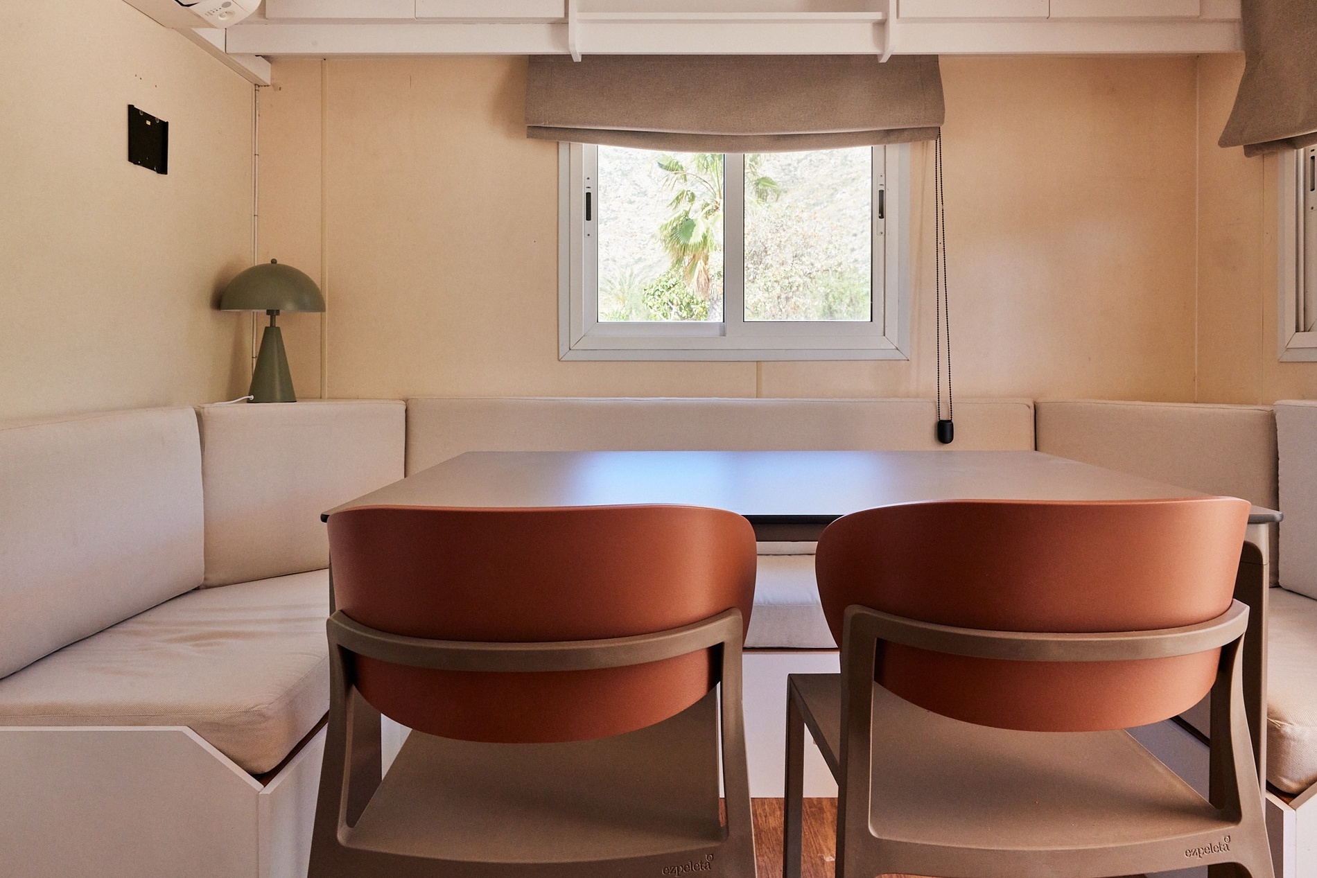 a dining room with a table and chairs and a window