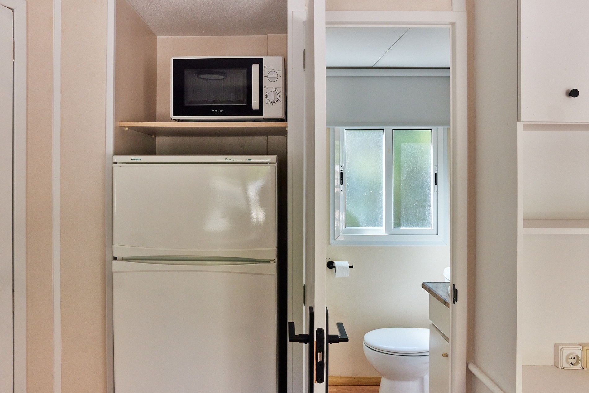 a white refrigerator with a microwave above it