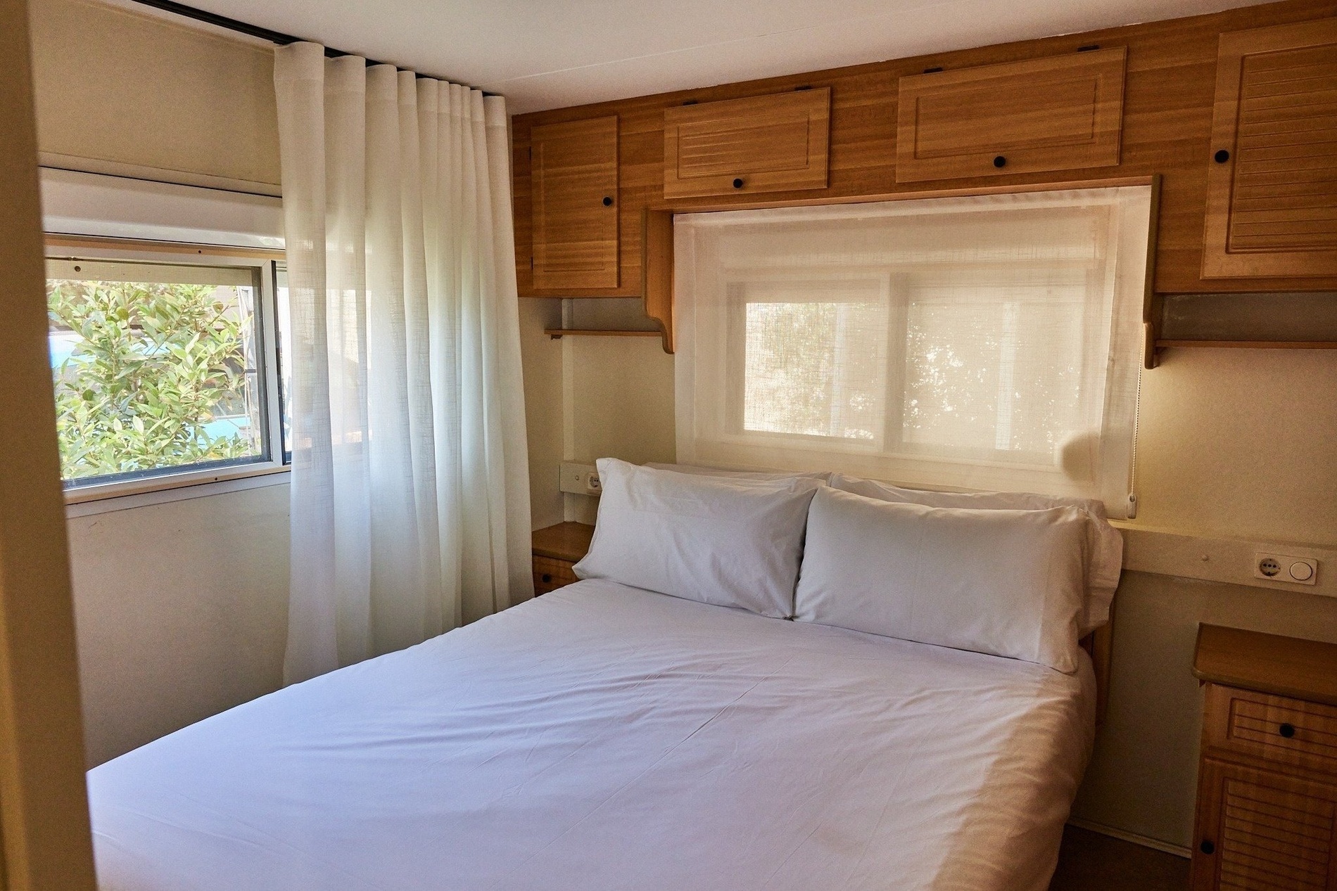 a small bedroom with a bed and a window