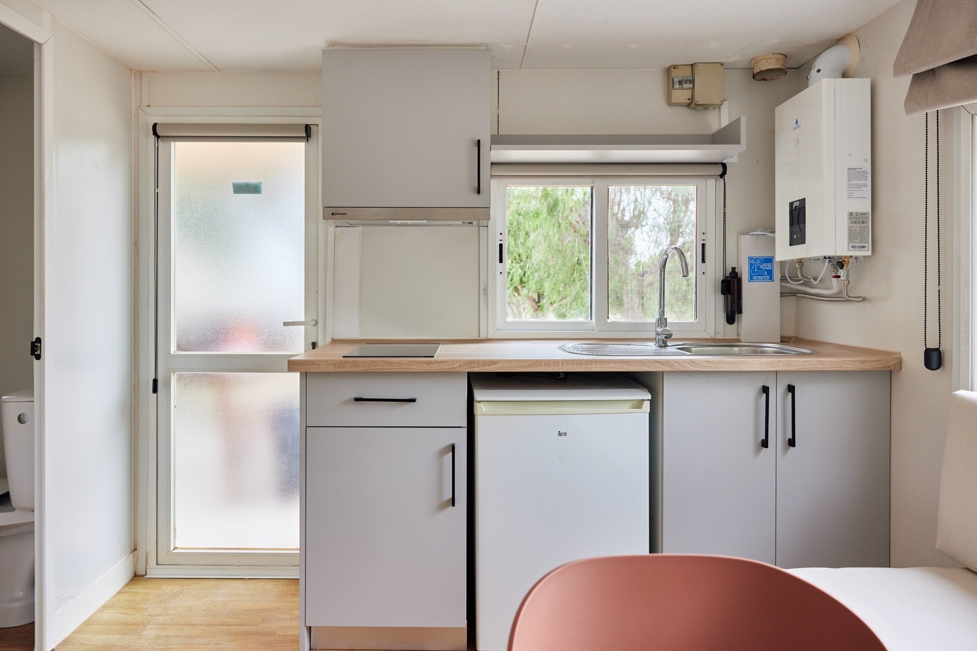 a kitchen with white cabinets and a white refrigerator