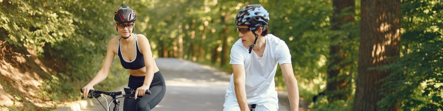 un hombre y una mujer andan en bicicleta por una carretera