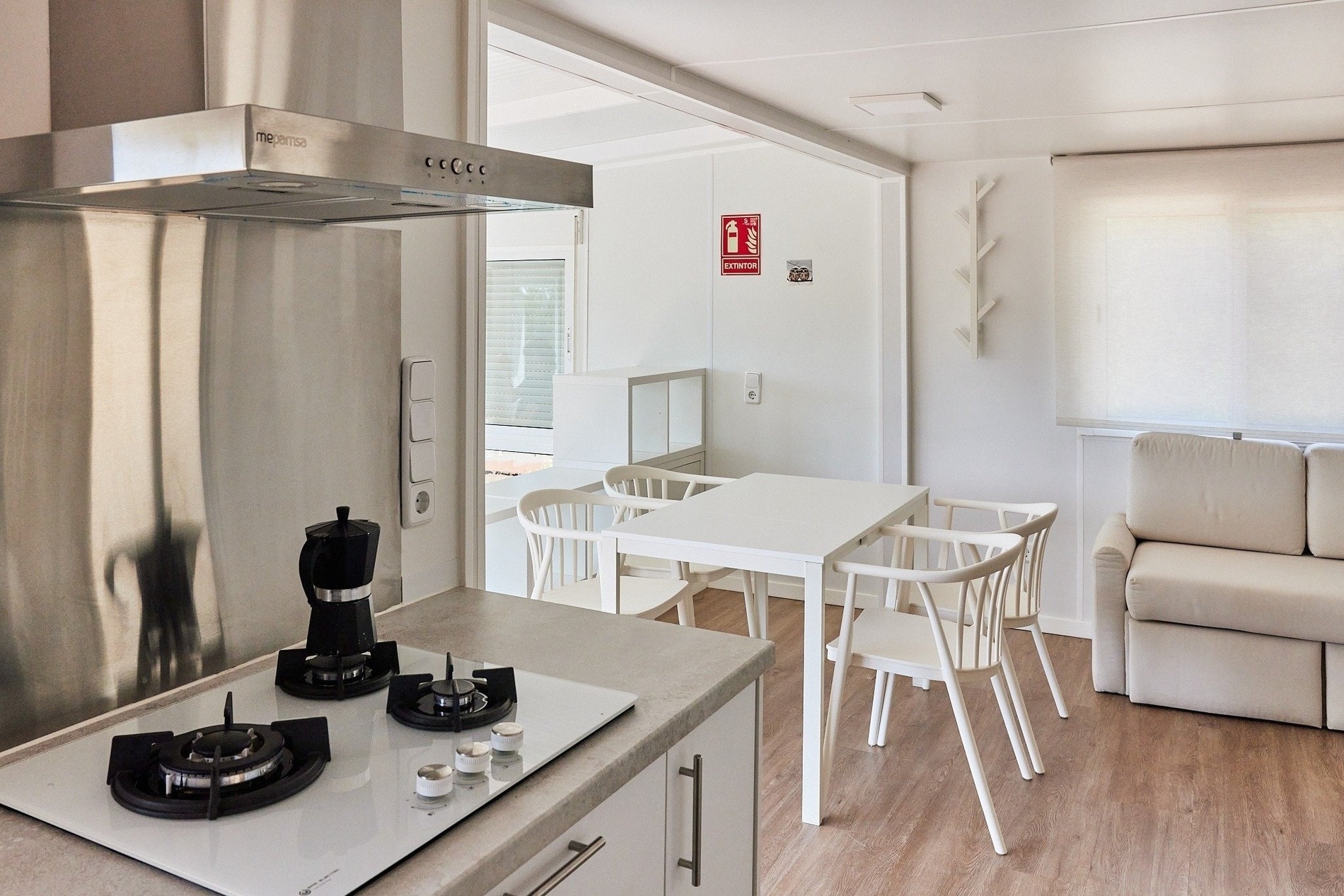 a kitchen with a fire extinguisher on the wall