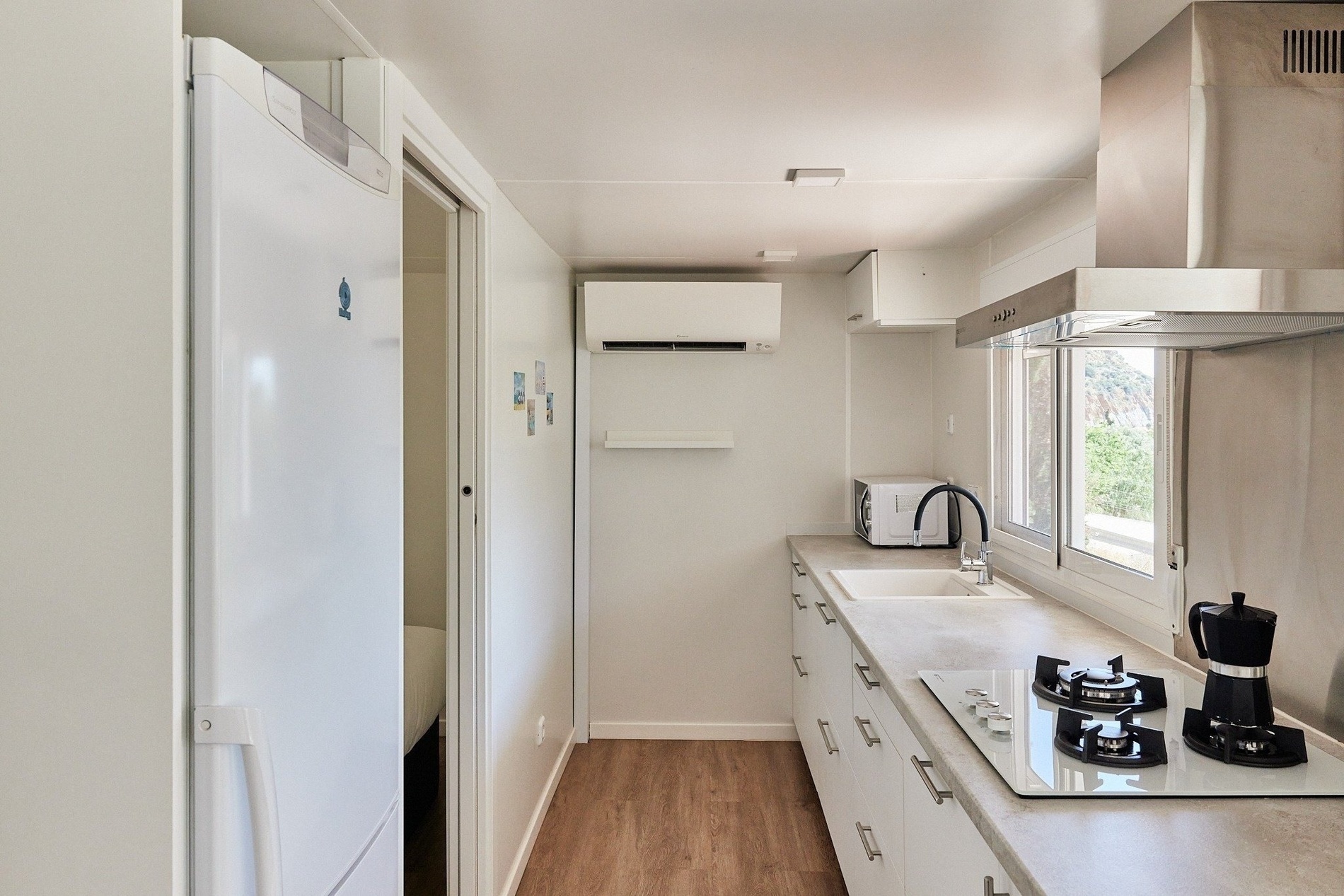 a kitchen with a white refrigerator and a stove top oven