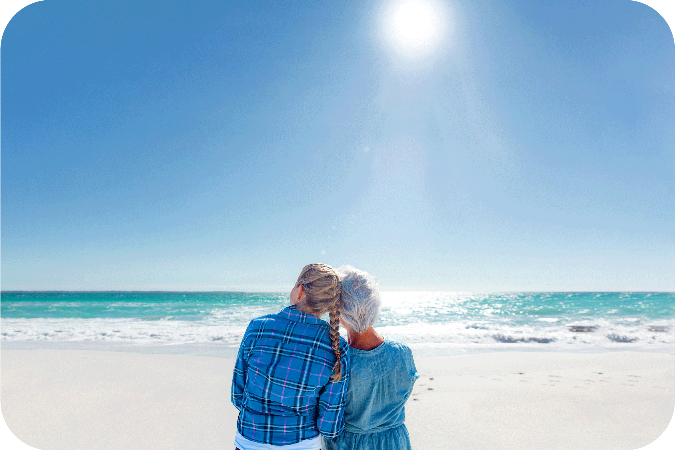 a man is carrying a child on his shoulders on the beach