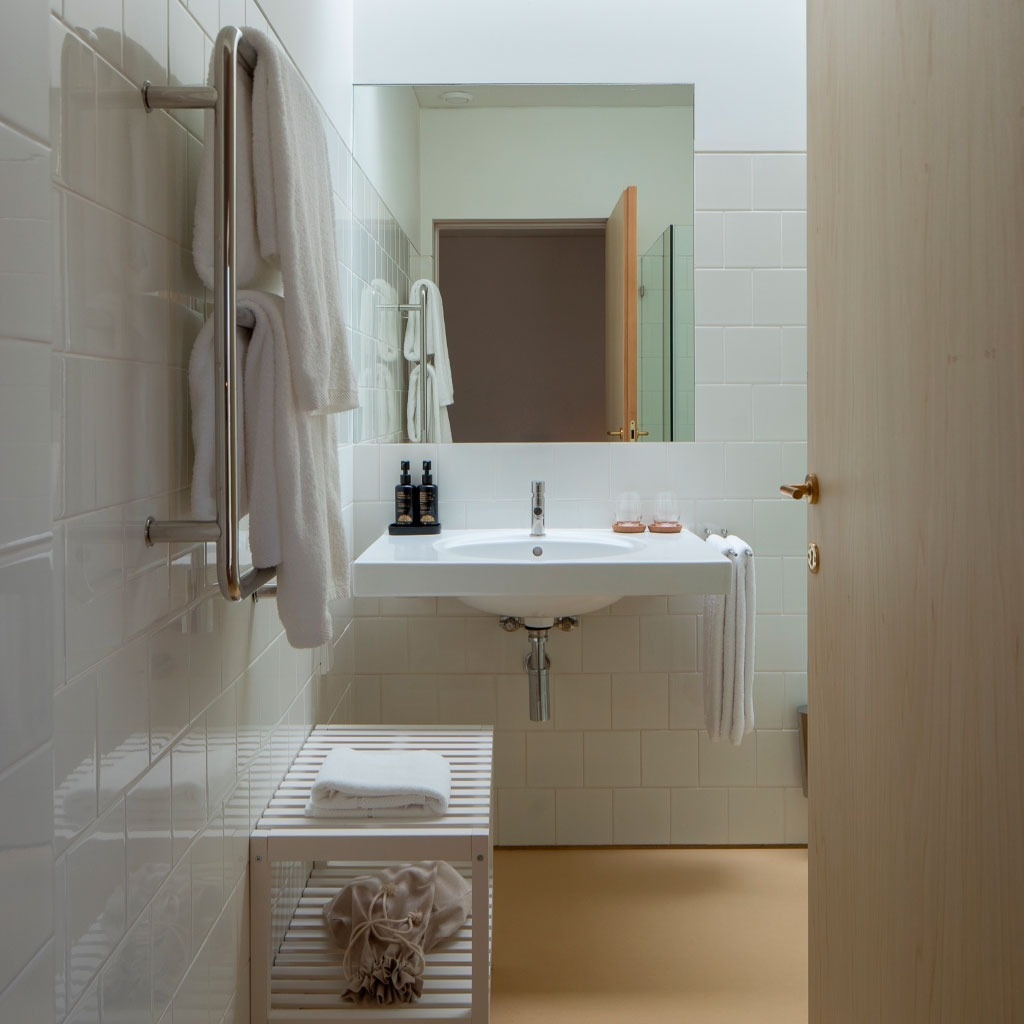 um banheiro branco com pia e espelho