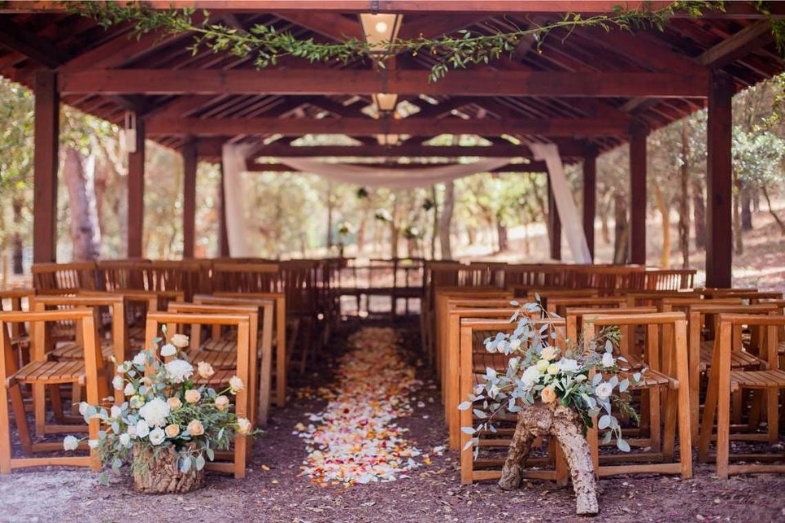a row of wooden chairs with flowers on them