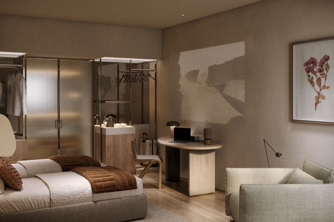 a bedroom with a bed and a desk with a laptop on it